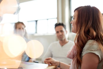 Unposed group of creative business people in an open concept office brainstorming their next project.-2